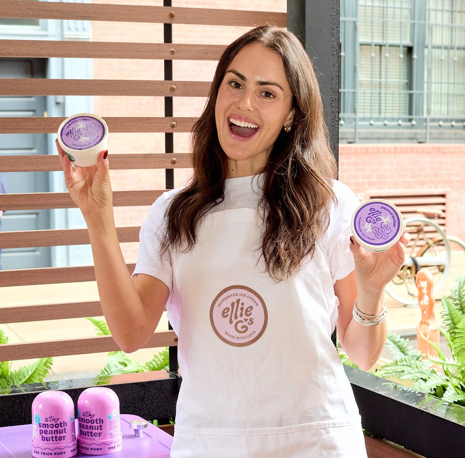 Ellie G holding up the One Trick Pony collaboration ice cream containers